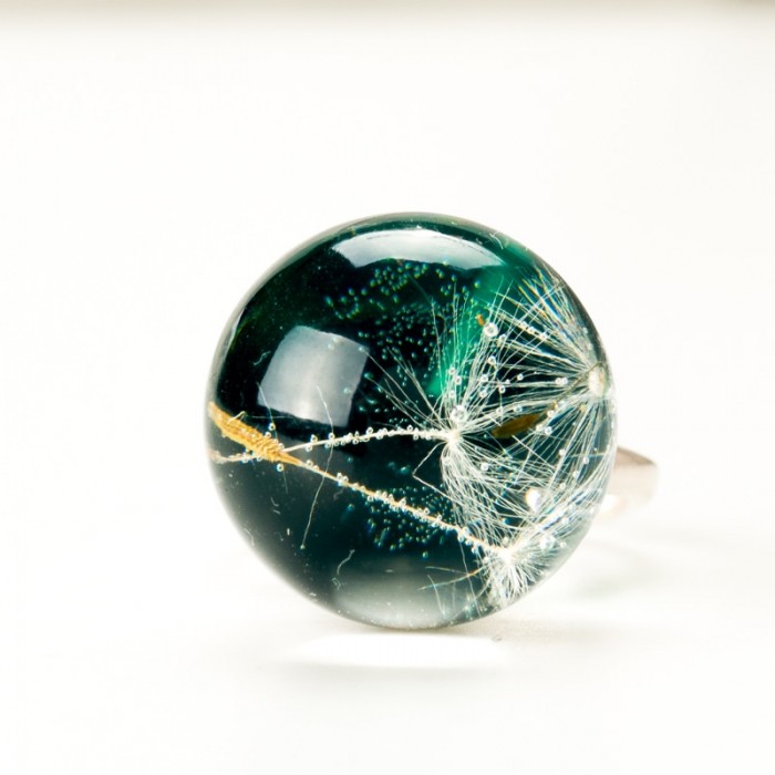 Pierścionek z zielonym oczkiem i dmuchawcem.